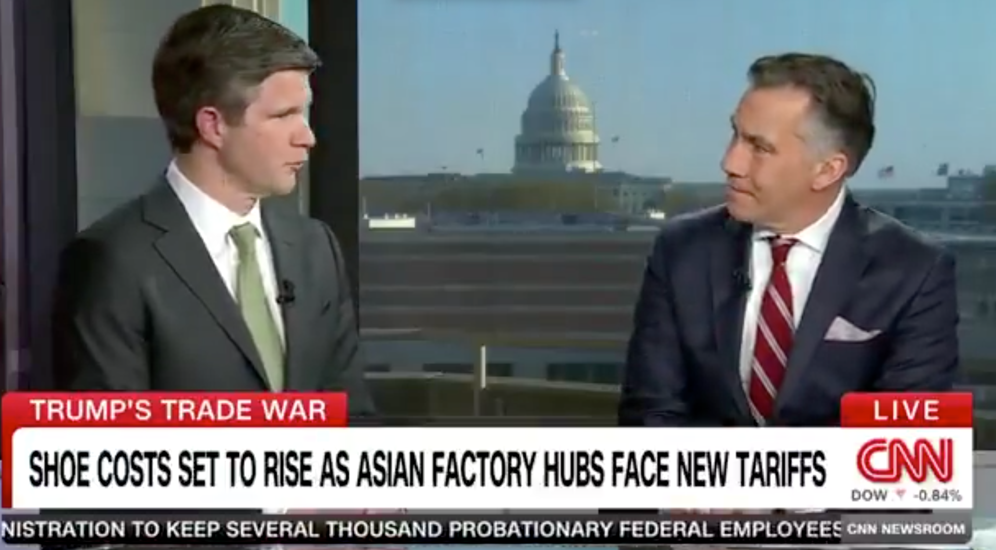 Two news anchors on CNN discuss tariffs affecting shoe costs, with the U.S. Capitol in the background. A headline reads: "Shoe costs set to rise."
