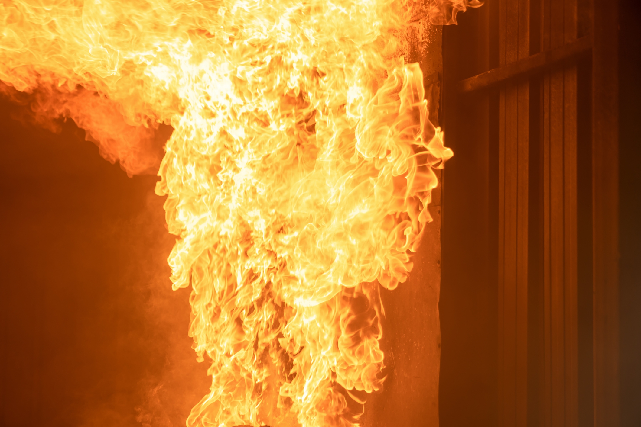Flames engulf a section of a building, illustrating a fiery and intense scene