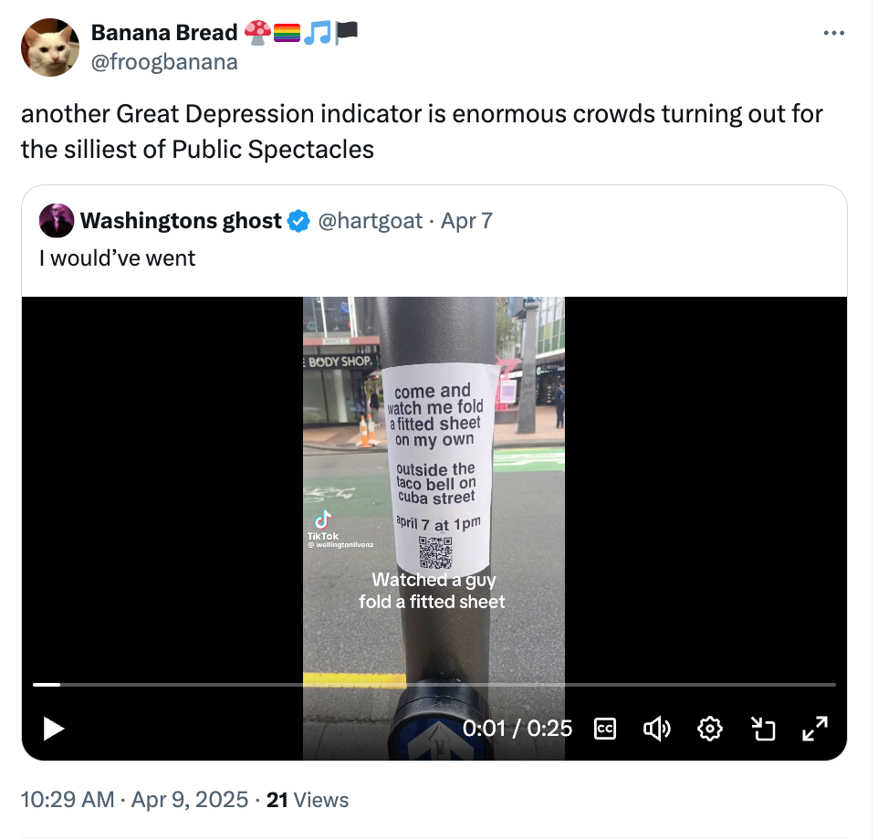 Tweet showing a video of a fitted sheet on a pole, with a text overlay expressing humor about public spectacles during tough times