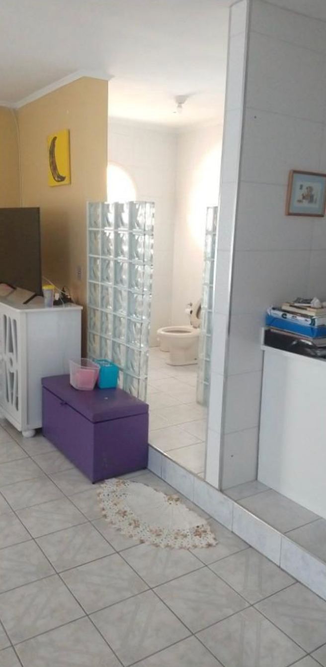 Another view of the bathroom scene with a glass block wall with no door