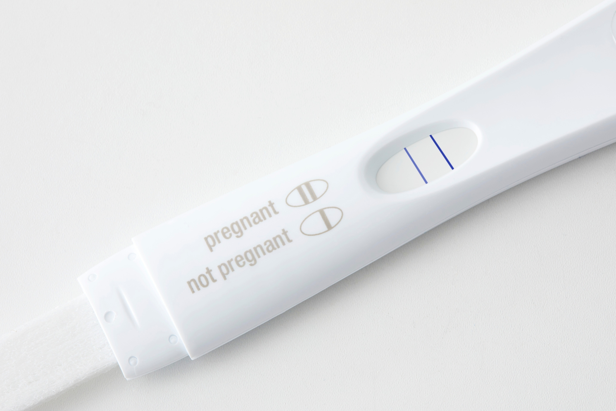 A positive pregnancy test with two lines visible on the display