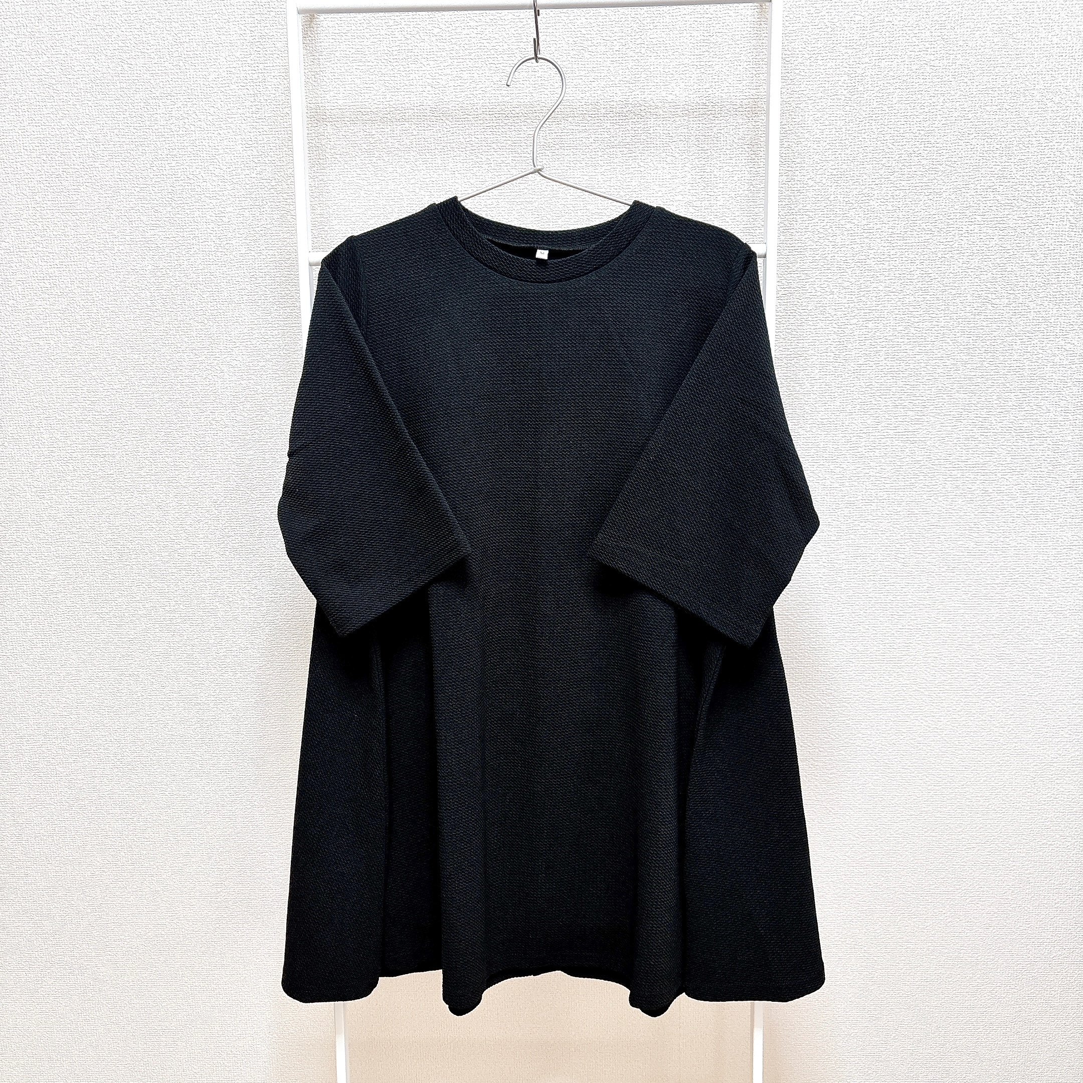 シンプルなデザインの半袖Tシャツがハンガーにかかっている。