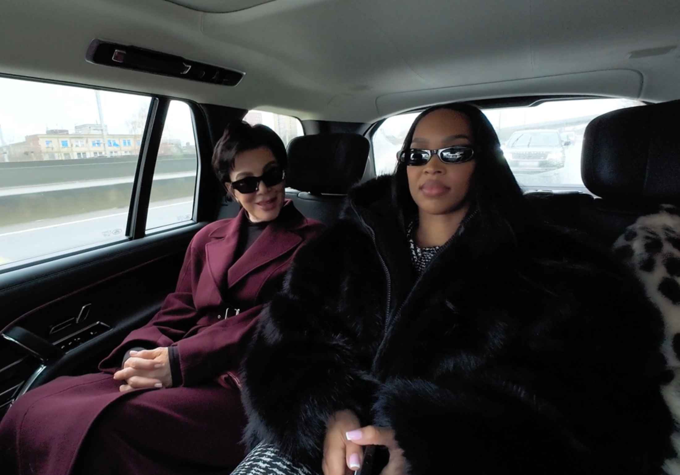 Kris Jenner smiling next to Malika Haqq in the back of a car