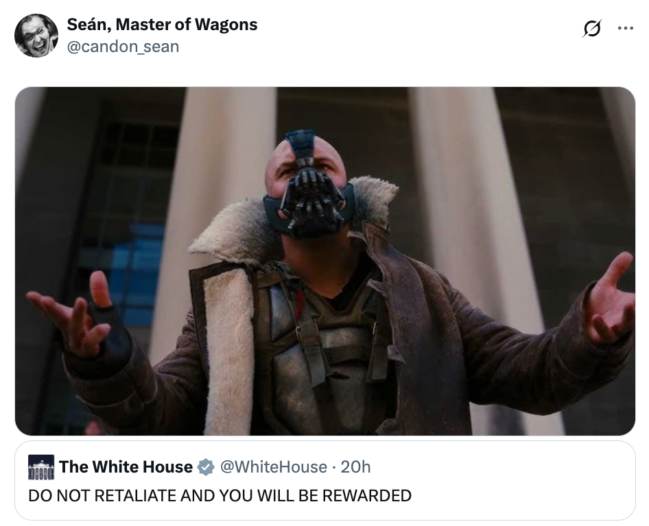 A character with a mask raises arms in a dramatic pose in front of tall columns. A tweet reads: "DO NOT RETALIATE AND YOU WILL BE REWARDED."