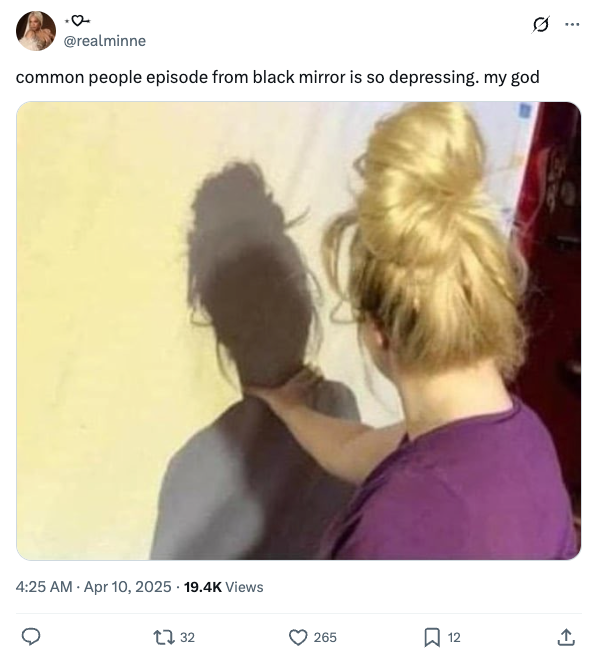 Person with hair in a bun, wearing a casual top, reaches towards their shadow on the wall. Tweet comments on a "Black Mirror" episode