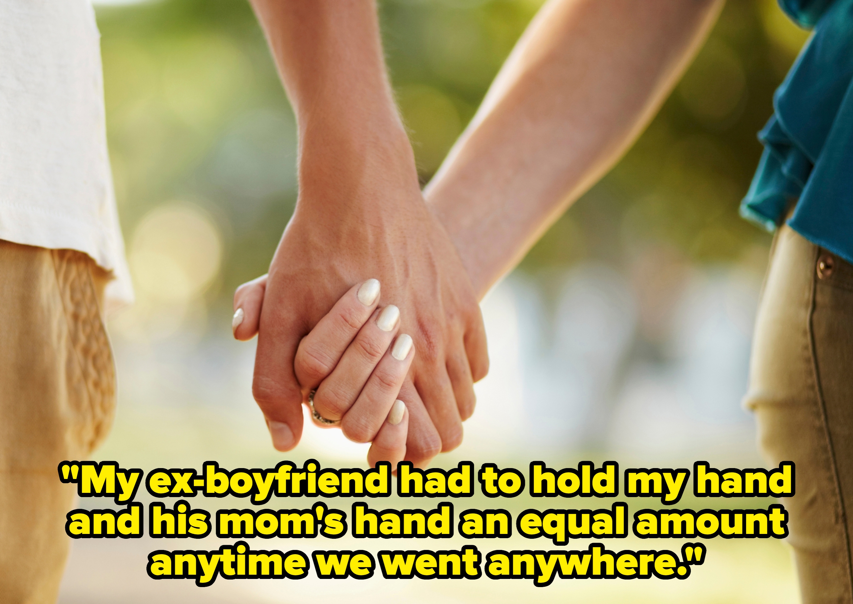 Two people holding hands outdoors