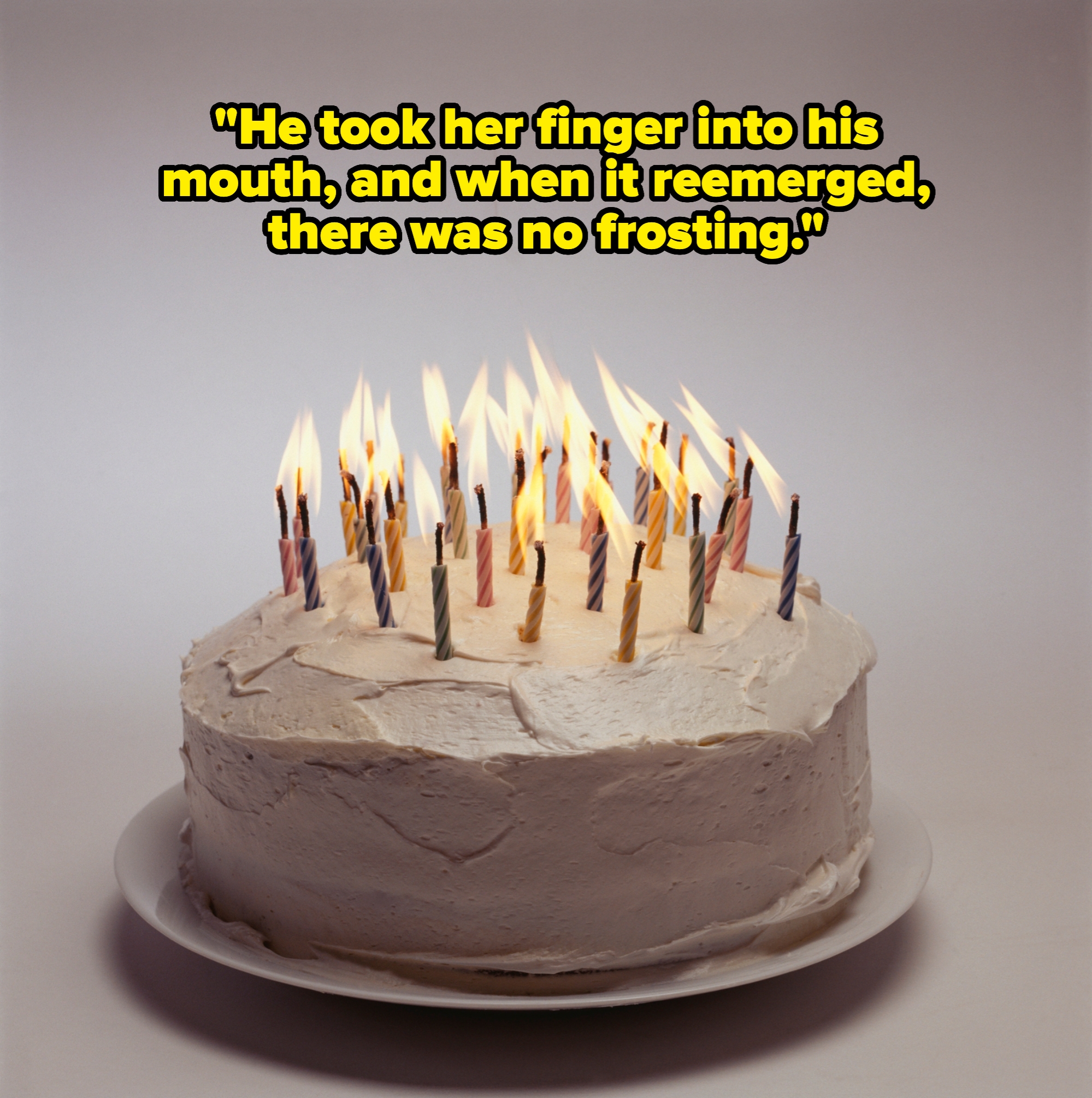 A cake topped with numerous lit candles