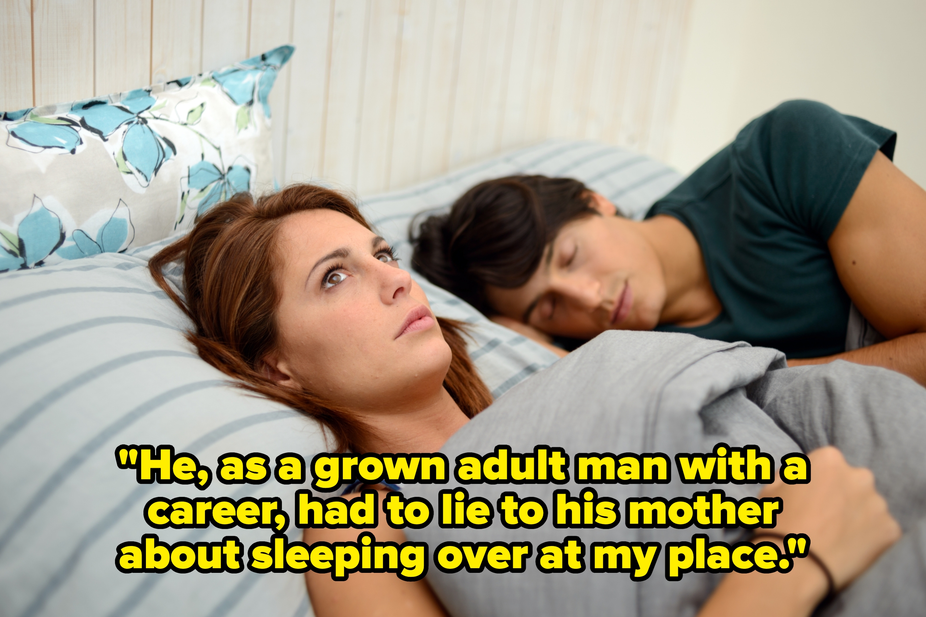 Woman lying awake in bed, looking concerned, while a person sleeps beside her