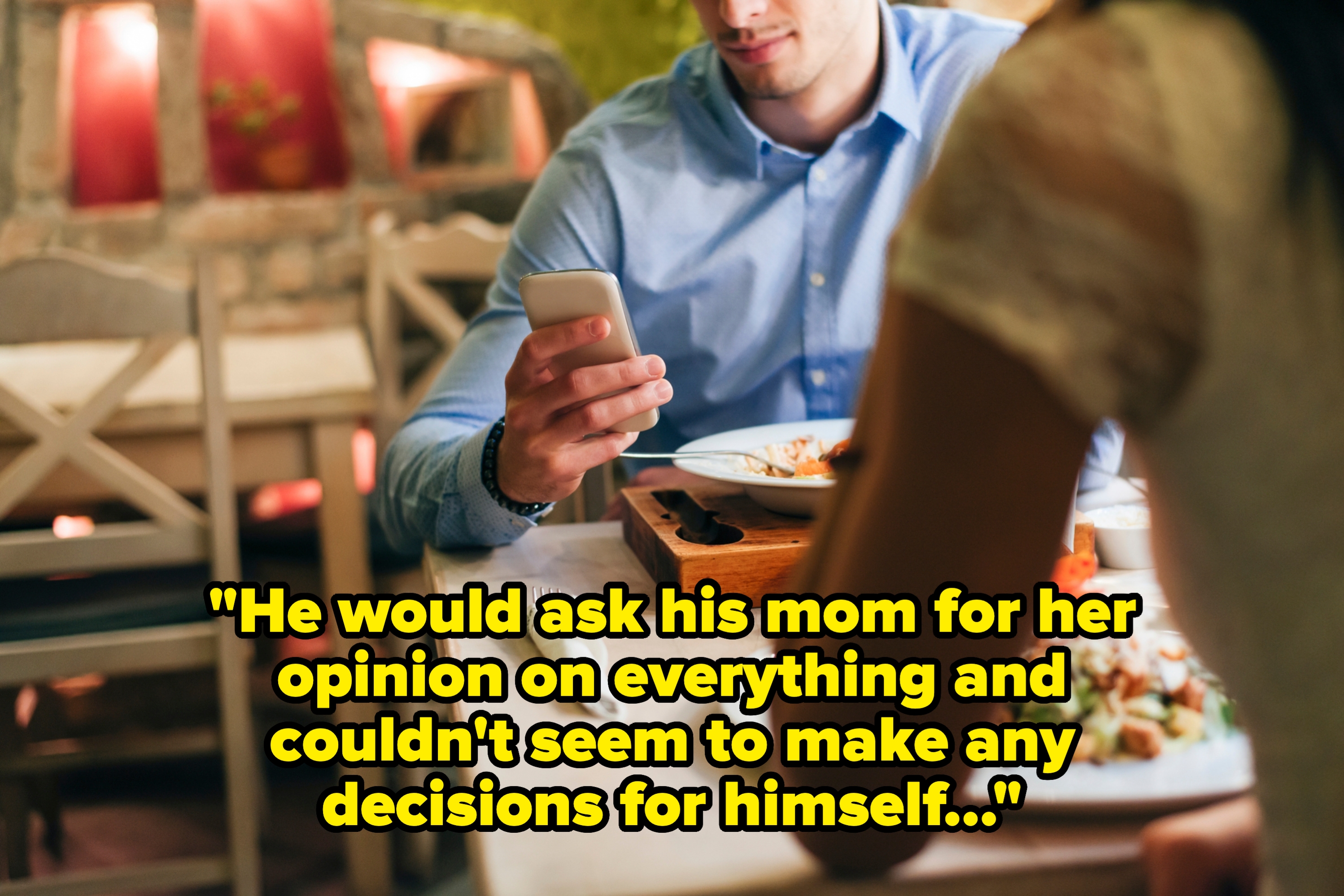 Couple having dinner at a restaurant, one person distracted by smartphone while the other person looks at the meal