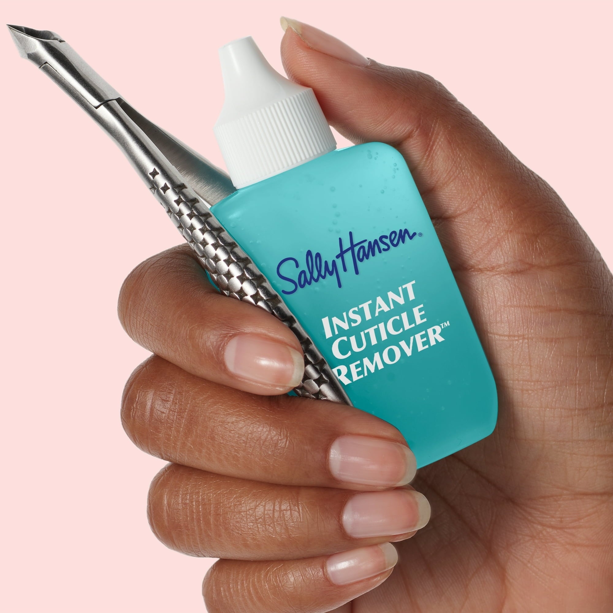 Memegang Tangan Sally Hansen Penghapus Kutikula Instan dan Puser Kutikula Logam