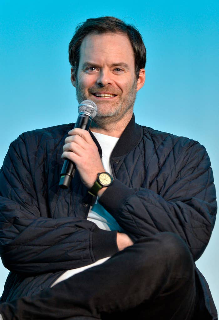 Bill Hader holding a microphone, smiling