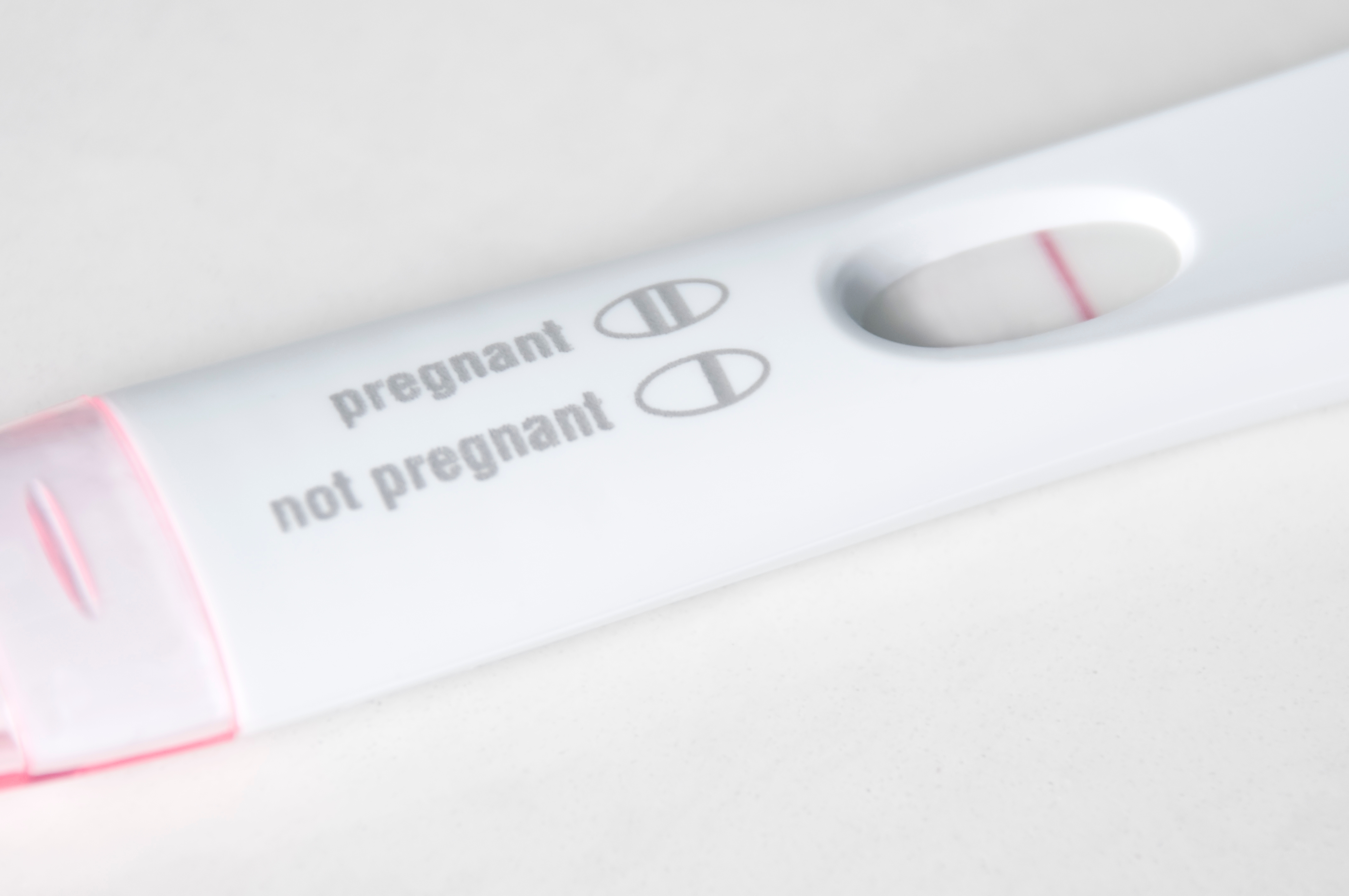 A pregnancy test shows a single line indicating a negative result, labeled "not pregnant."