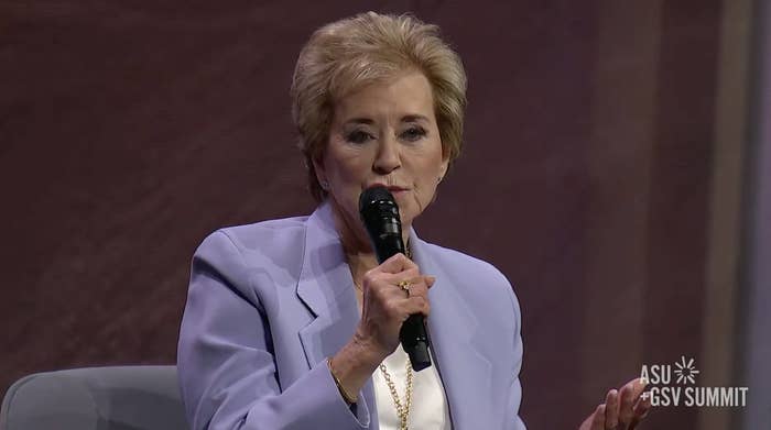 Linda McMahon holding a microphone, wearing a light-colored jacket, speaking at ASU+GSV Summit