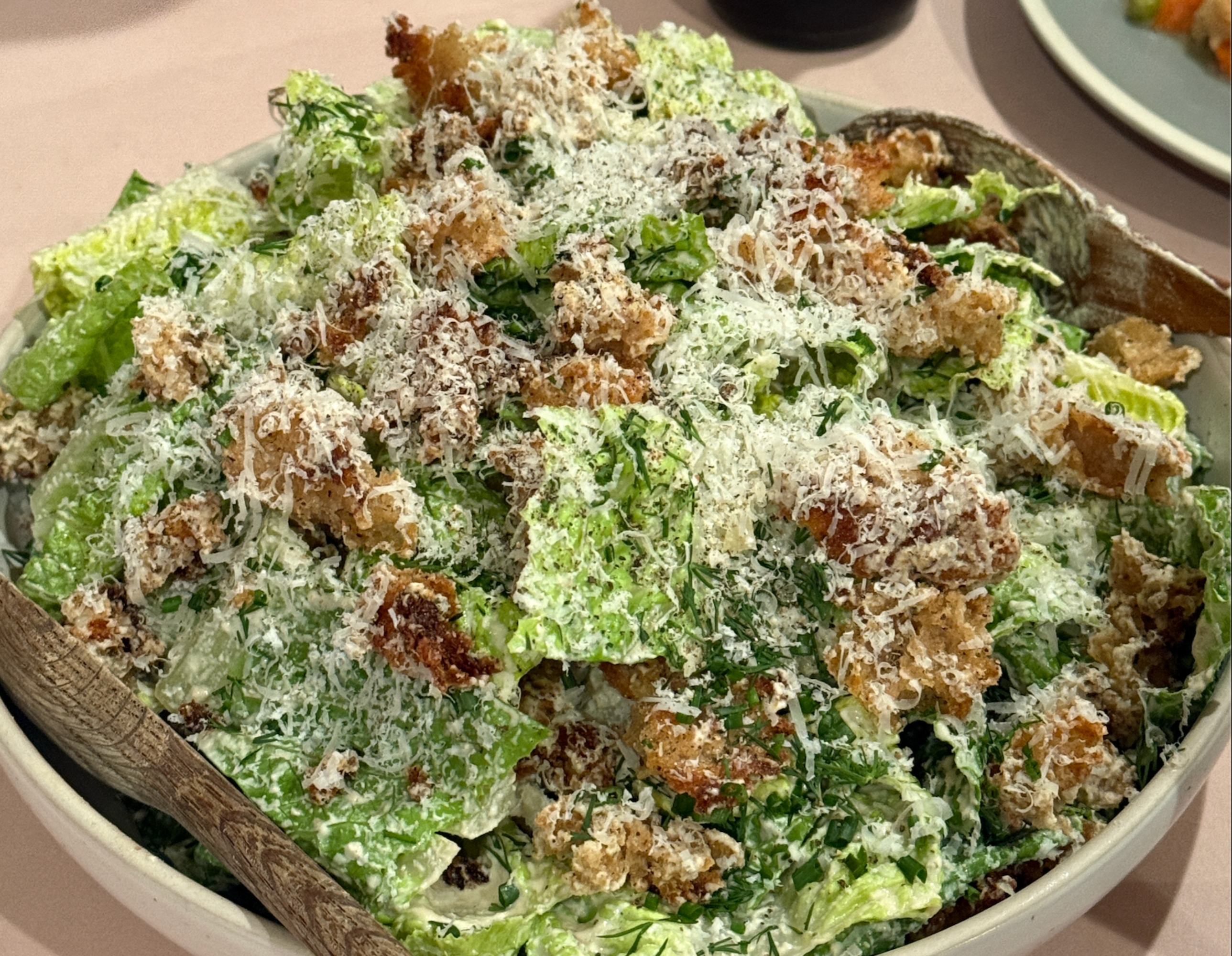 Caesar salad with croutons, grated cheese, and dressing