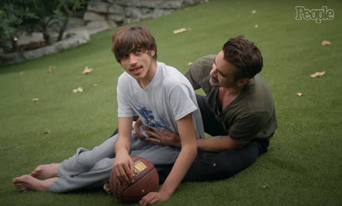 Colin Farrell embraces his son James on the grass