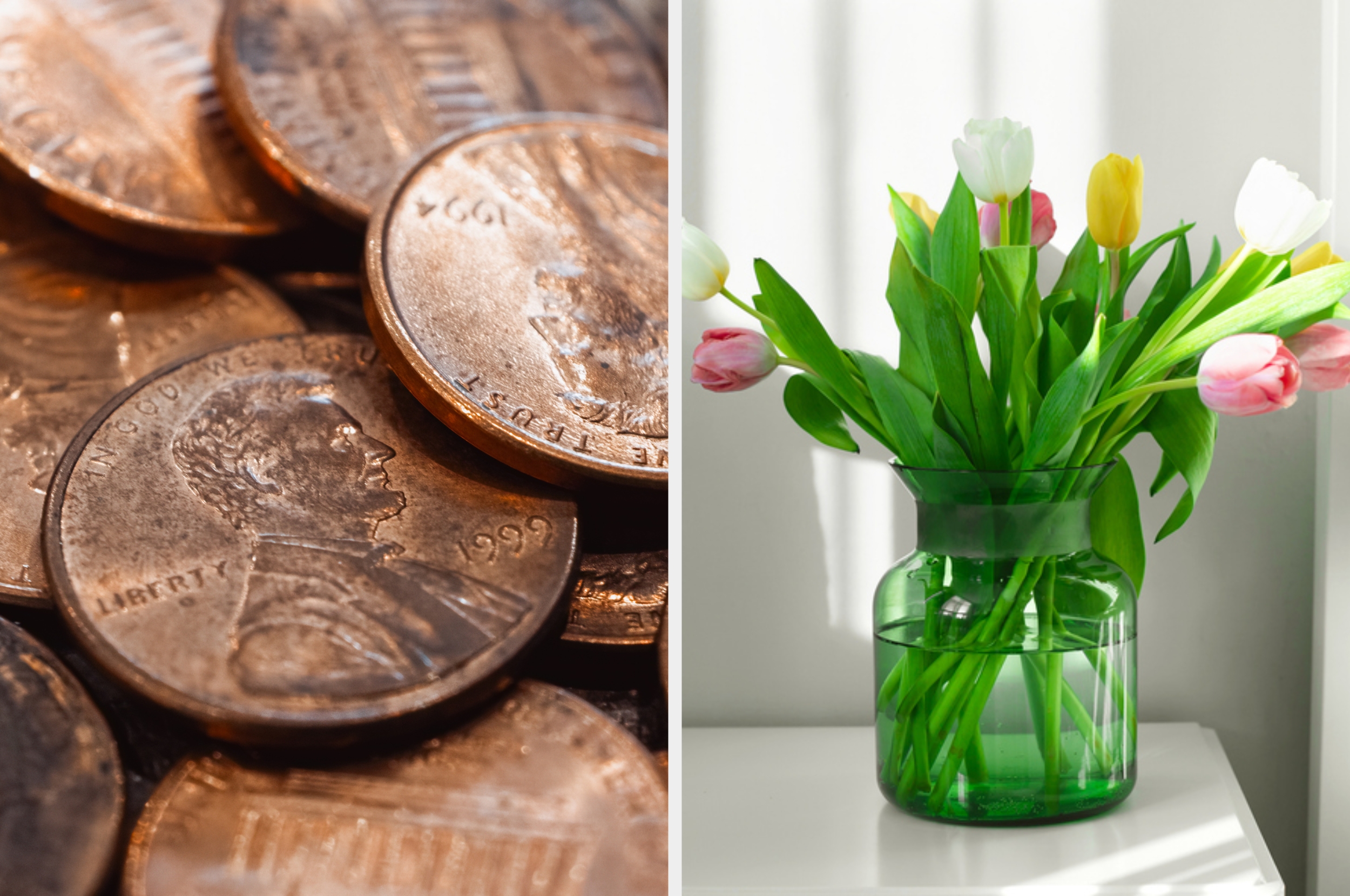 Close-up of a stack of pennies next to a glass vase filled with blooming tulips on a white surface
