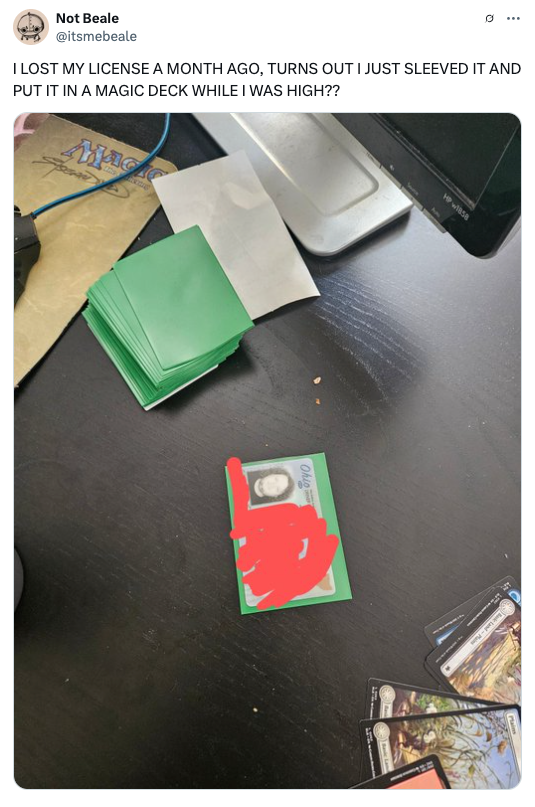 A desk with a driver's license in a card sleeve, surrounded by playing cards. A tweet above humorously mentions losing the license in a card deck