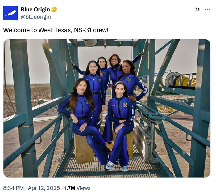 Group of six individuals in blue space uniforms pose on a platform structure, associated with Blue Origin's NS-31 crew event