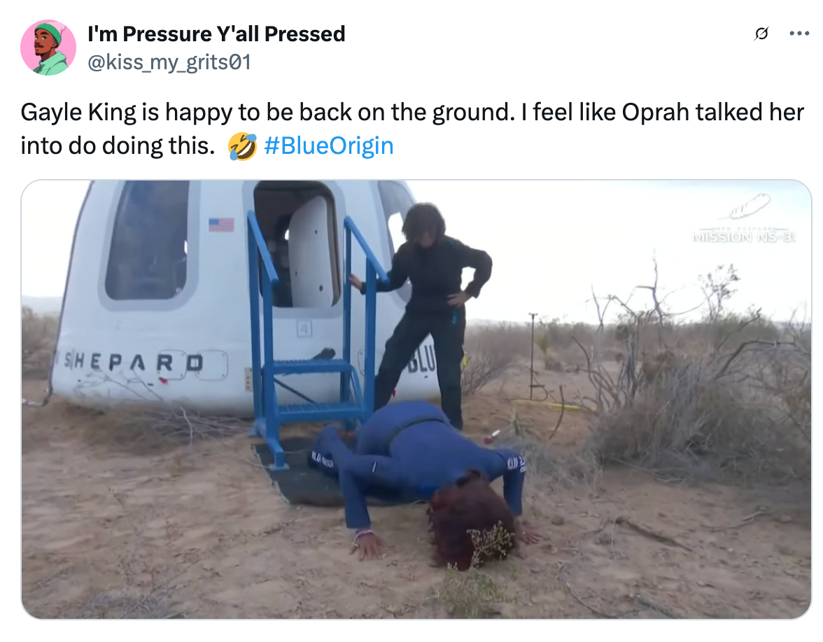 A person lies face down on the ground outside a space capsule, while another stands nearby smiling. The tweet jokes about space travel