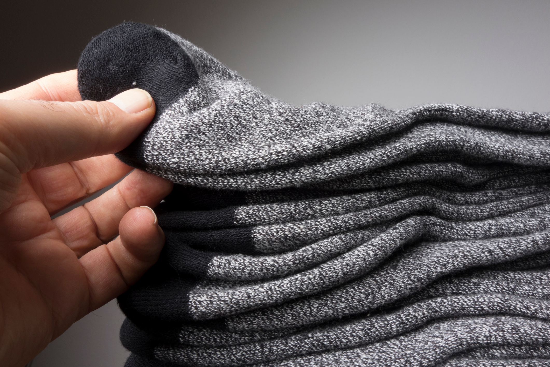 Hand holding a stack of neatly folded socks