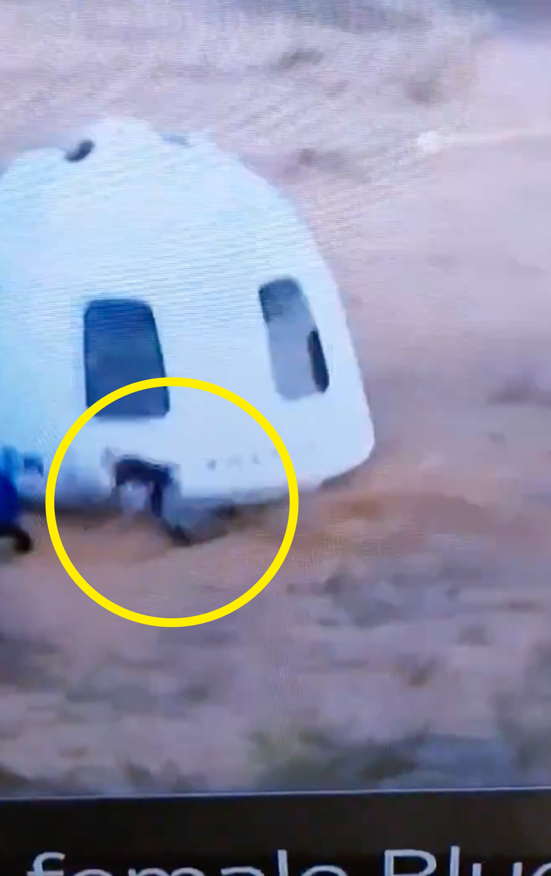 A capsule has landed in a desert area, with people approaching it, possibly a space mission landing or simulation