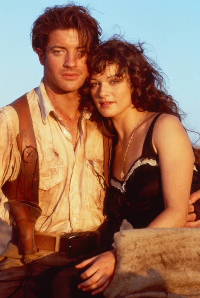 Two actors pose together in period adventure attire, evoking a classic movie scene with rugged and stylish elements