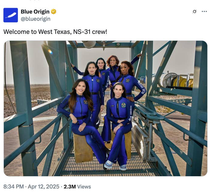 Five crew members in blue space jumpsuits pose on a metal structure for Blue Origin's NS-31 mission in West Texas
