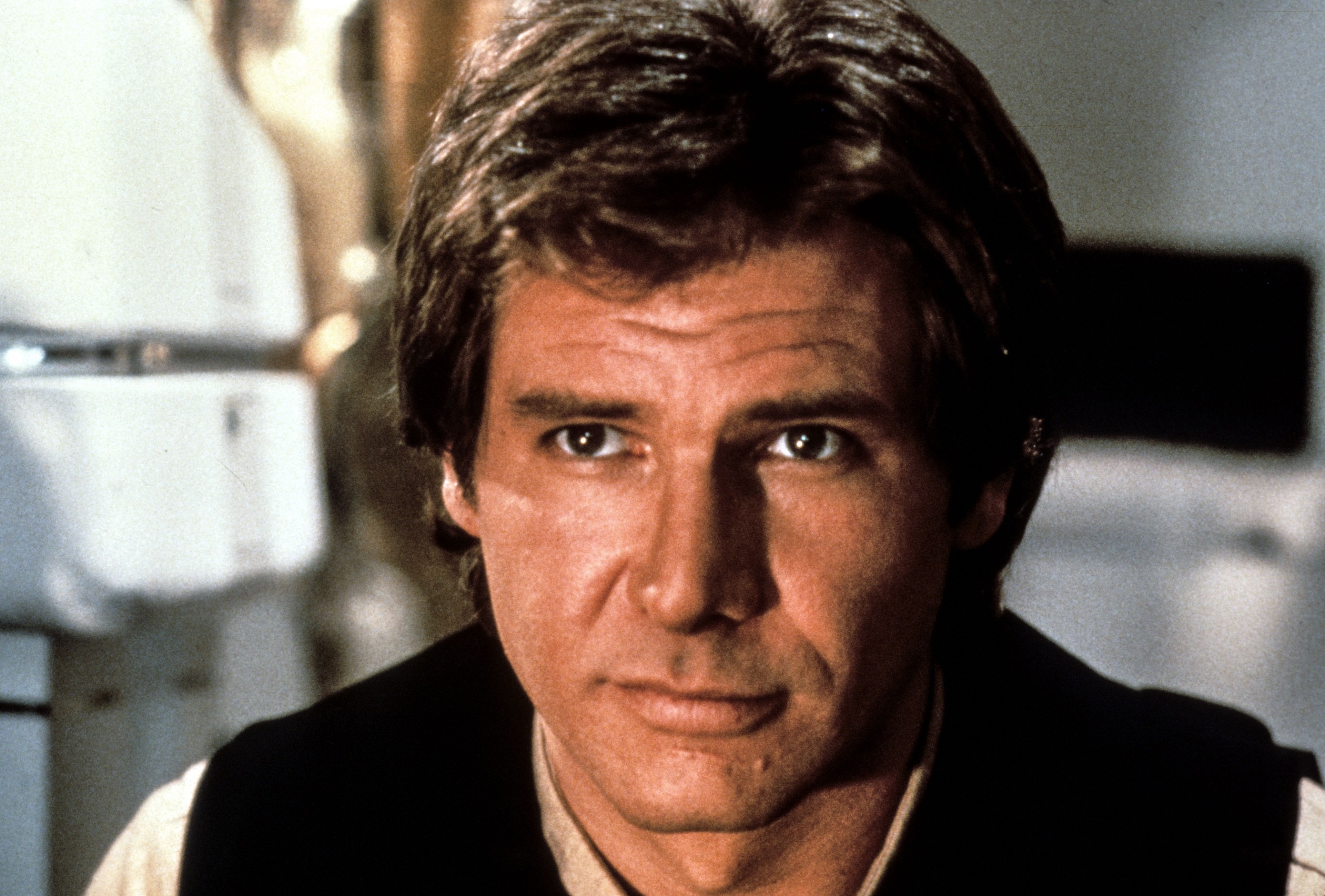 Actor in a sci-fi film scene, wearing a casual vest and shirt. The setting is futuristic, likely from a popular movie franchise