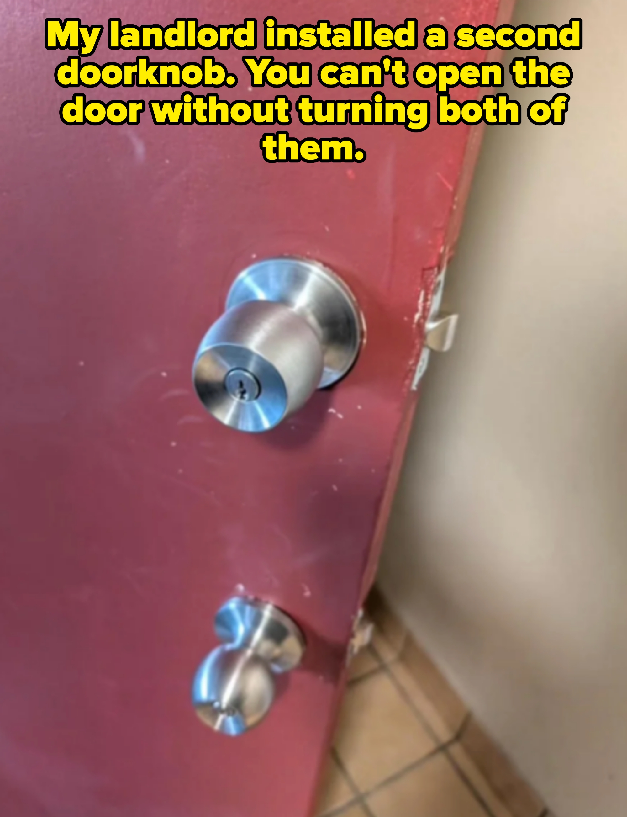 two door handles on a door captioned, "My landlord installed a second doorknob. You can't open the door without turning both of them"