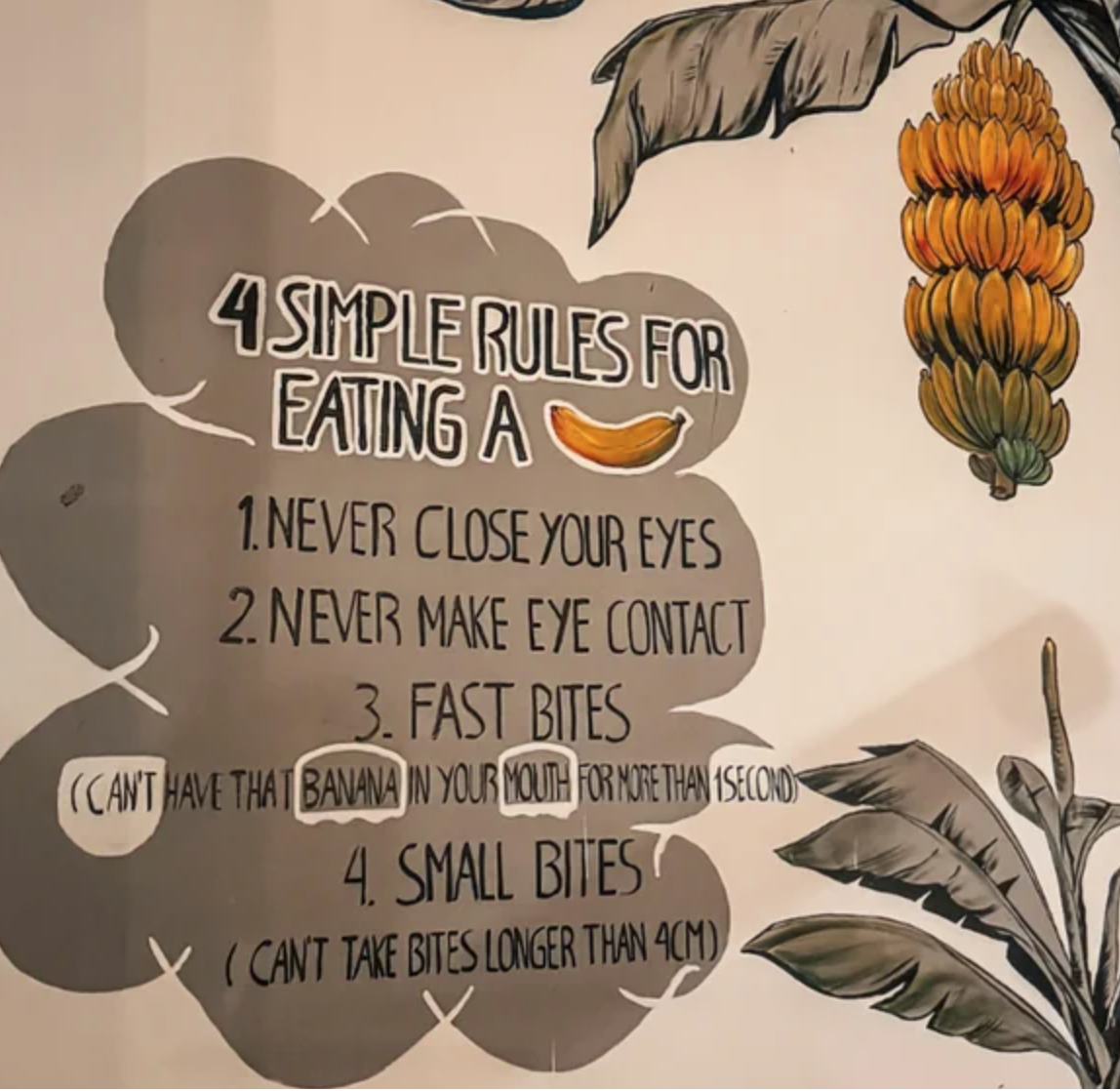 Humorous wall art with eating rules for bananas: no eye contact, fast bites (short in mouth), small bites (under 4cm)
