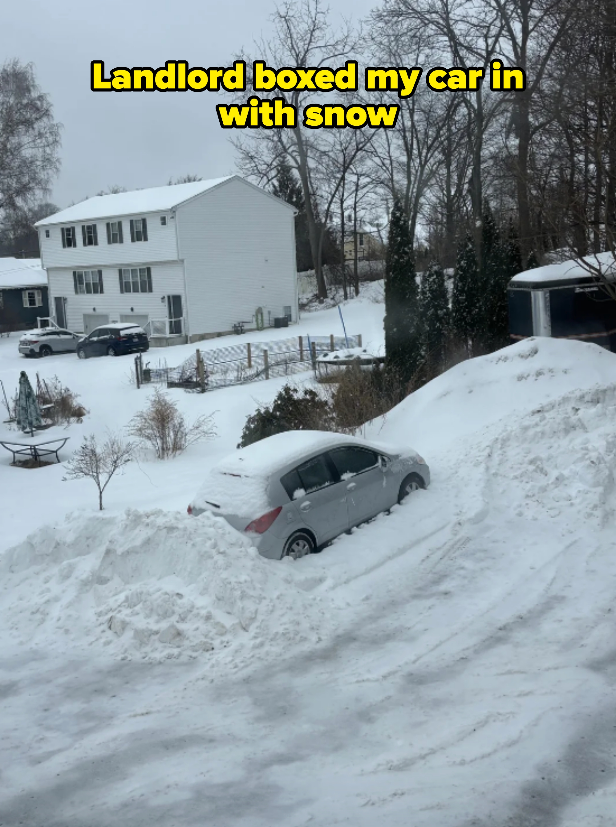Car stuck in snow on a residential street during winter — caption: "landlord boxed my car in with snow"