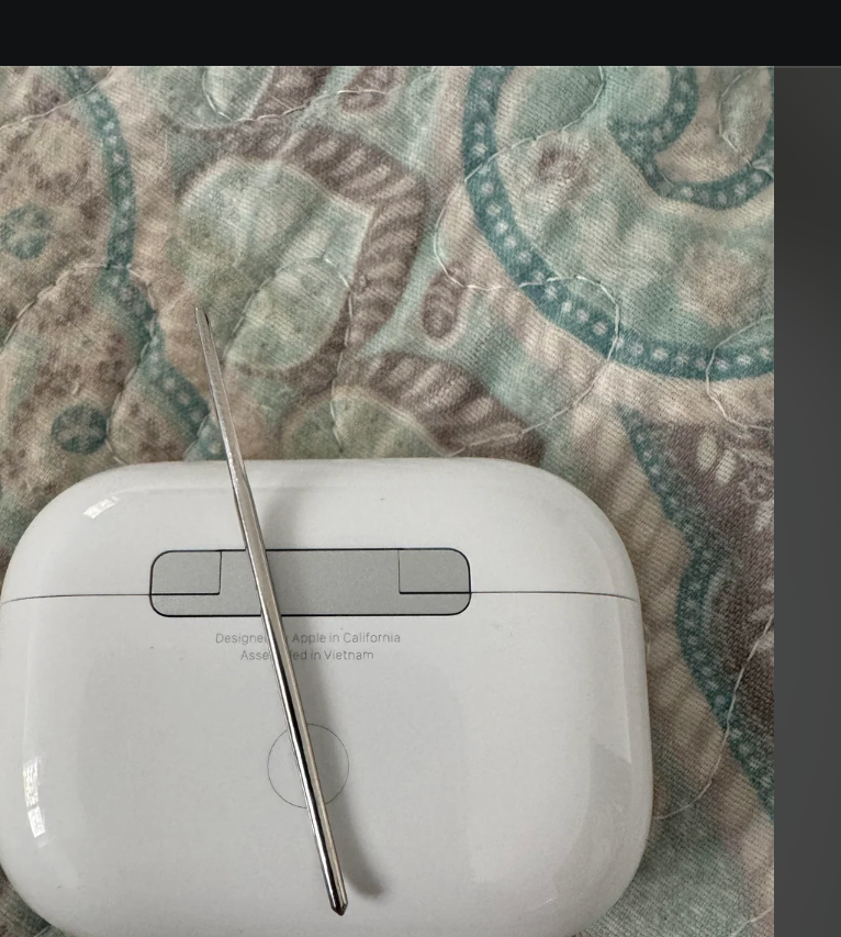 Screenshot of a Reddit post showing AirPods case used to help align a sewing needle while threading