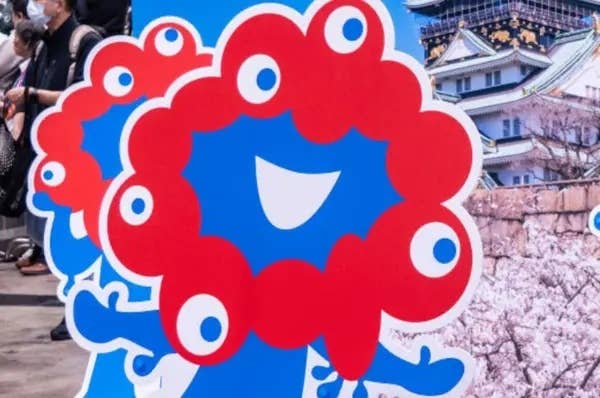 キャラクターの看板が大阪城の前に配置され、訪問者が周囲を歩いている様子。