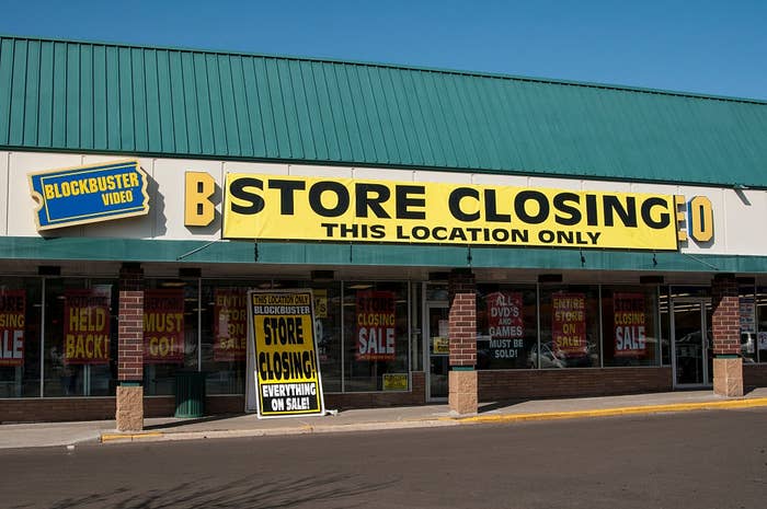 Storefront of Blockbuster Video with signs announcing a store closing sale