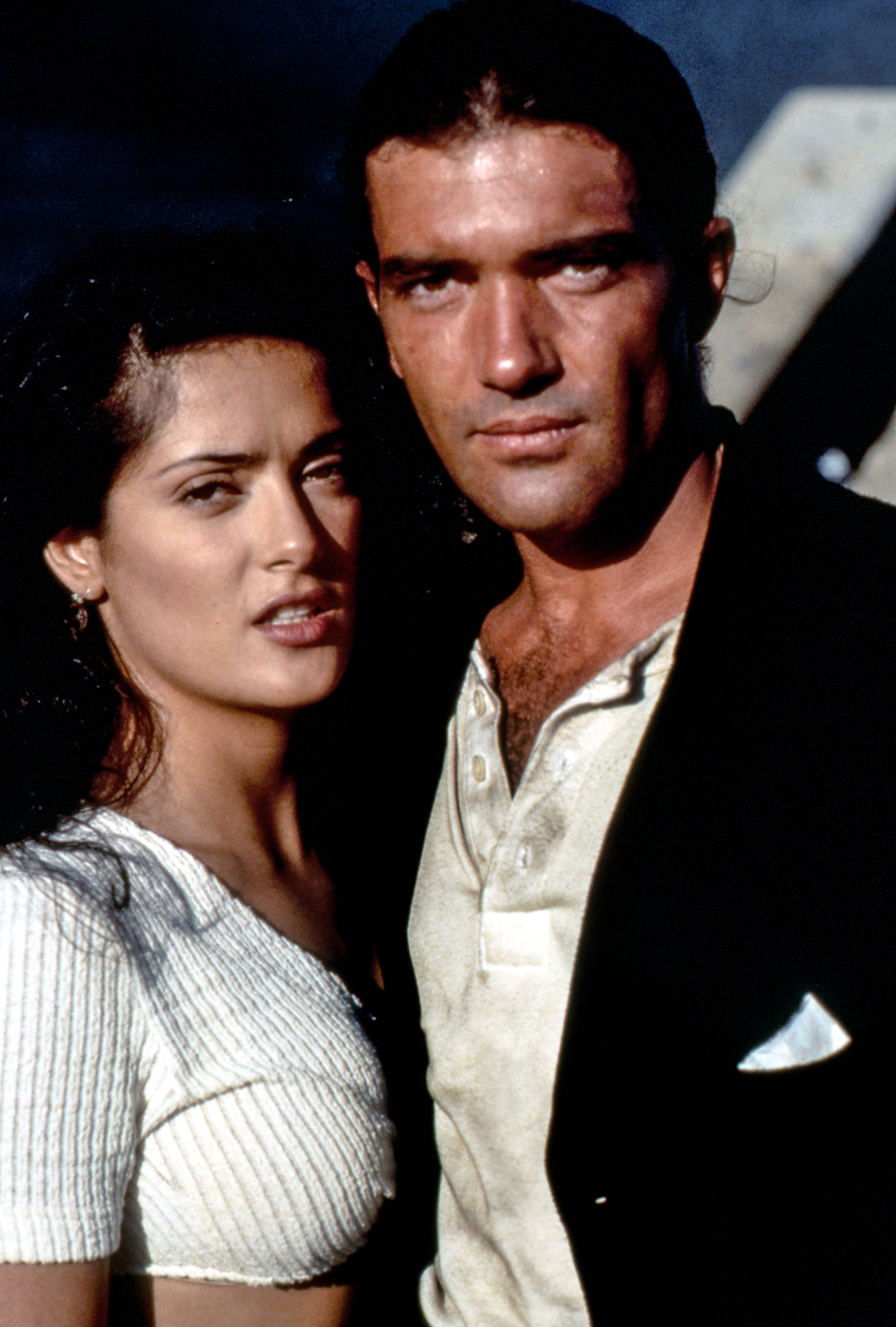 Two actors in 90s style clothing, posing dramatically on a film set