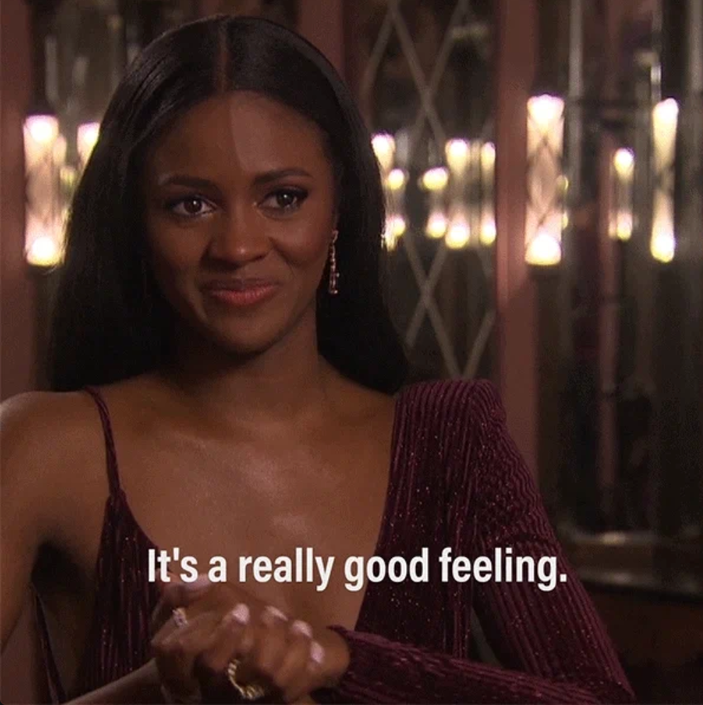 Person smiling with hands clasped, wears an elegant one-shoulder gown. Text on image reads: "It's a really good feeling."