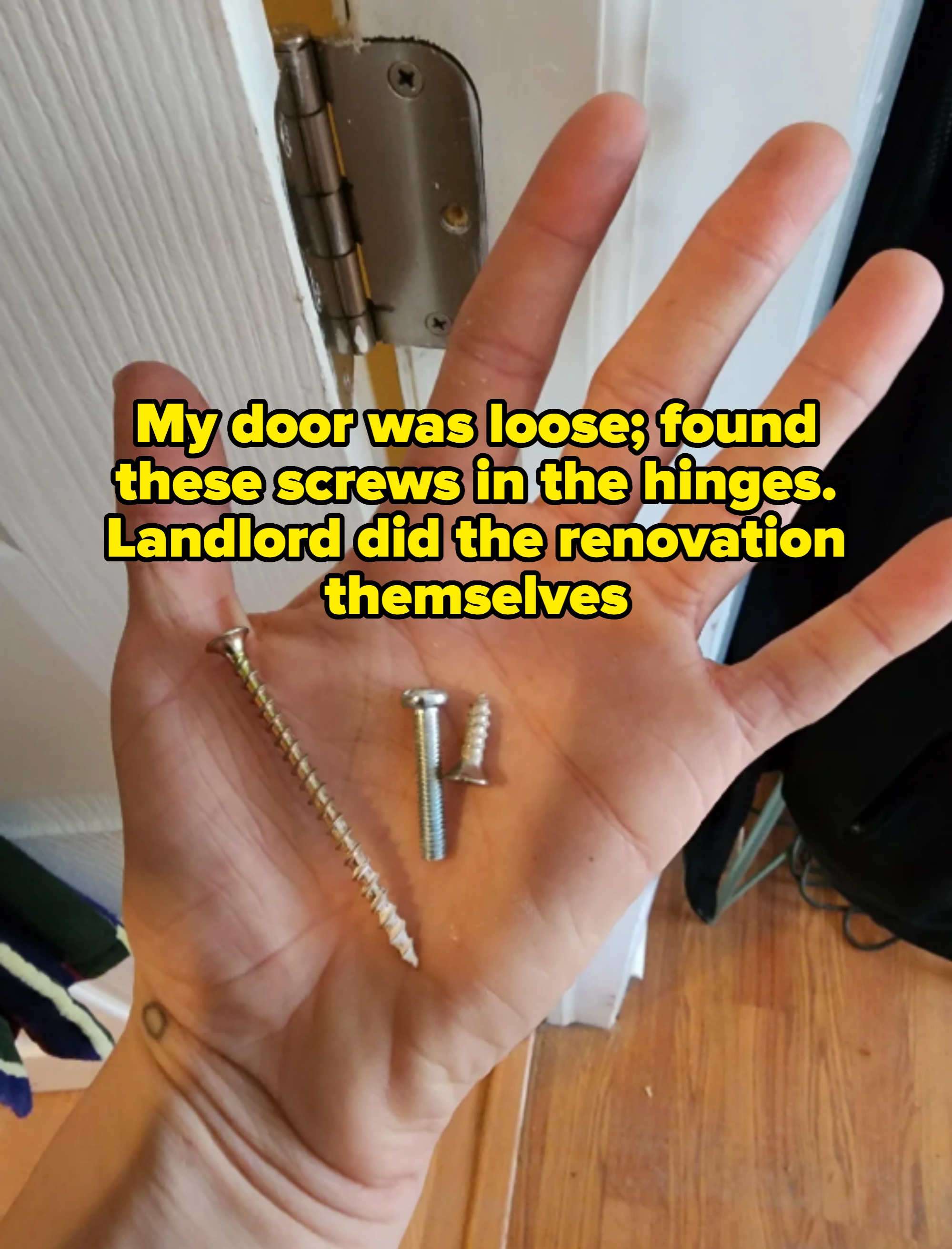 Hand holding three screws of different sizes, with a door hinge visible in the background. Caption: "My door was loose; found these screws in the hinges. Landlord did the renovation themselves"