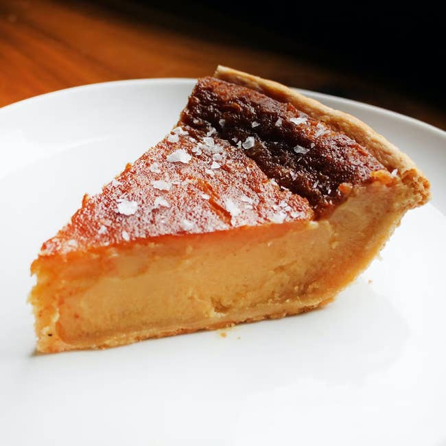 A portion of creamy pastry with a flaky crust is connected a achromatic plate, sprinkled with flaky oversea brackish connected top