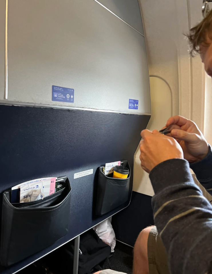 Person on a flight clipping nails in their seat. Image includes Reddit post layout and user comments