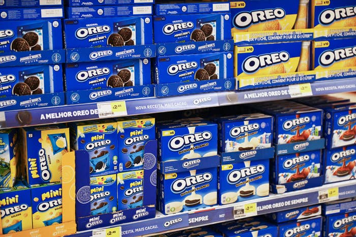 Grocery store shelf filled with various Oreo cookie packages, including regular, mini, and flavored varieties