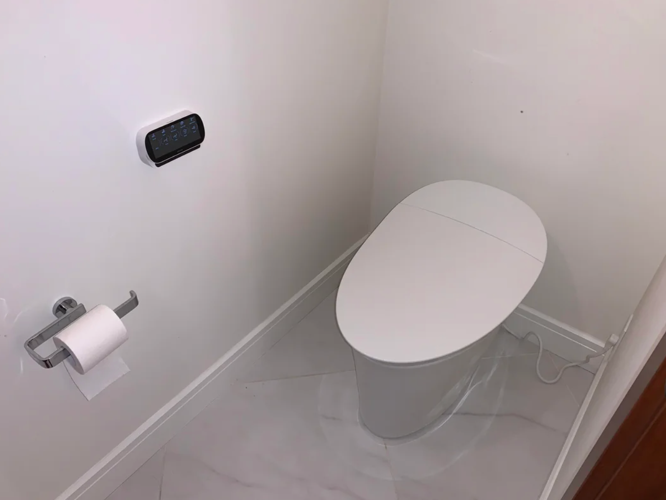 Reddit post showing a sleek, modern white toilet with a heated seat and cleansing features, installed in a bathroom setting