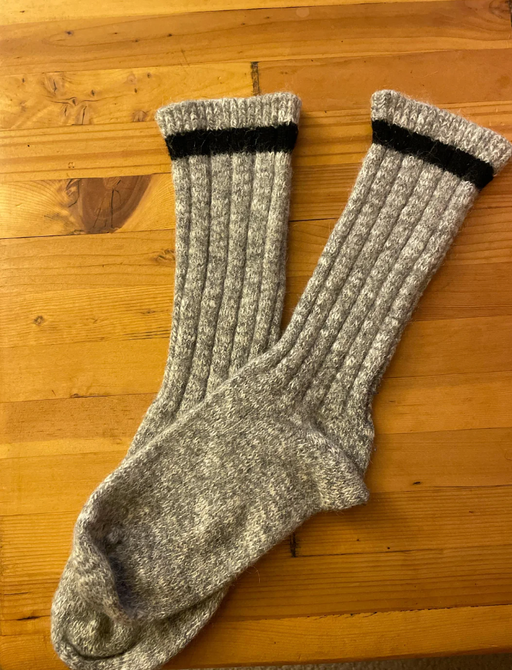 Reddit post discussing where to buy 100% wool socks, showcasing a pair of wool socks