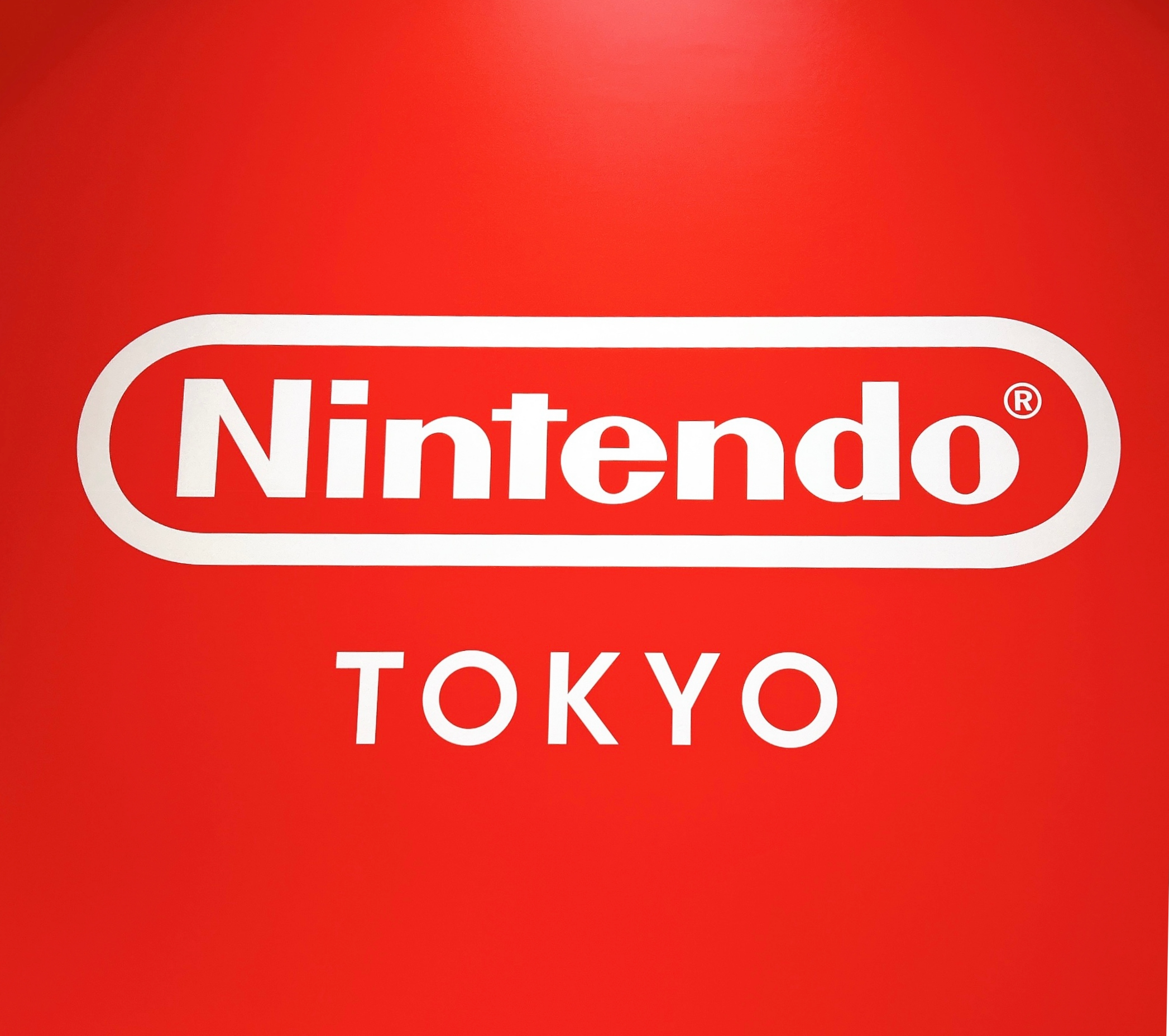 任天堂東京のロゴが赤い背景に表示されている。