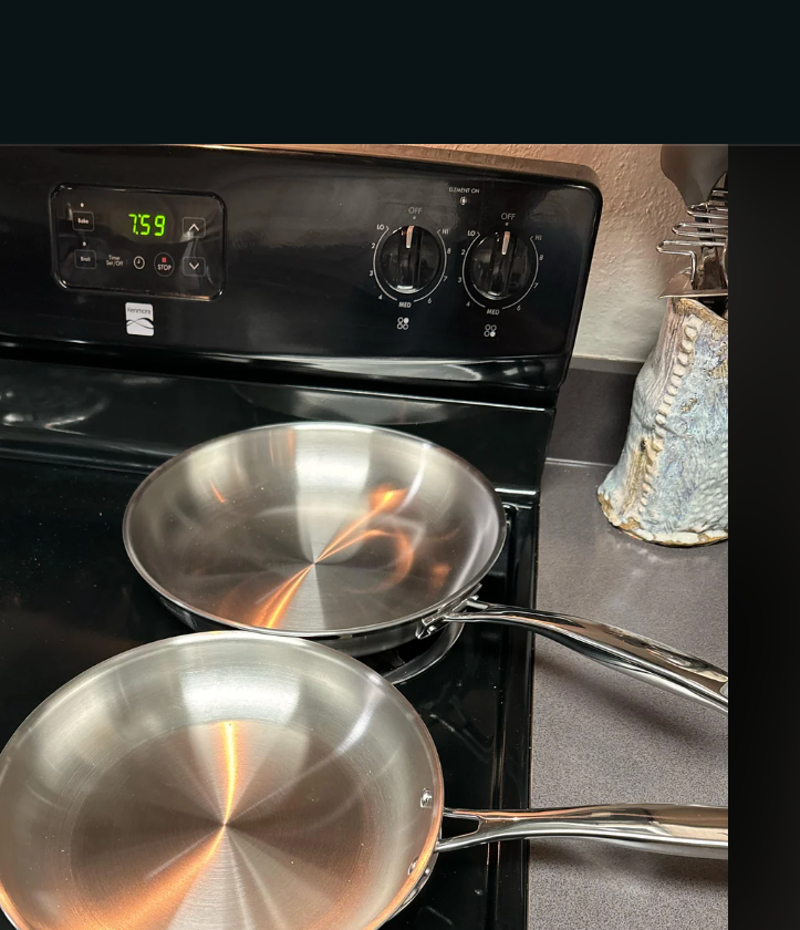 Reddit post in r/cookware: User seeks tips for using new stainless steel pans. Post shows two shiny pans on a stovetop