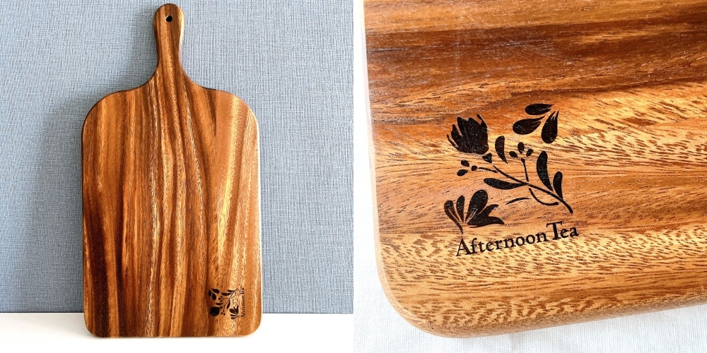 木製のまな板に「Afternoon Tea」と花のイラストが刻まれている。
