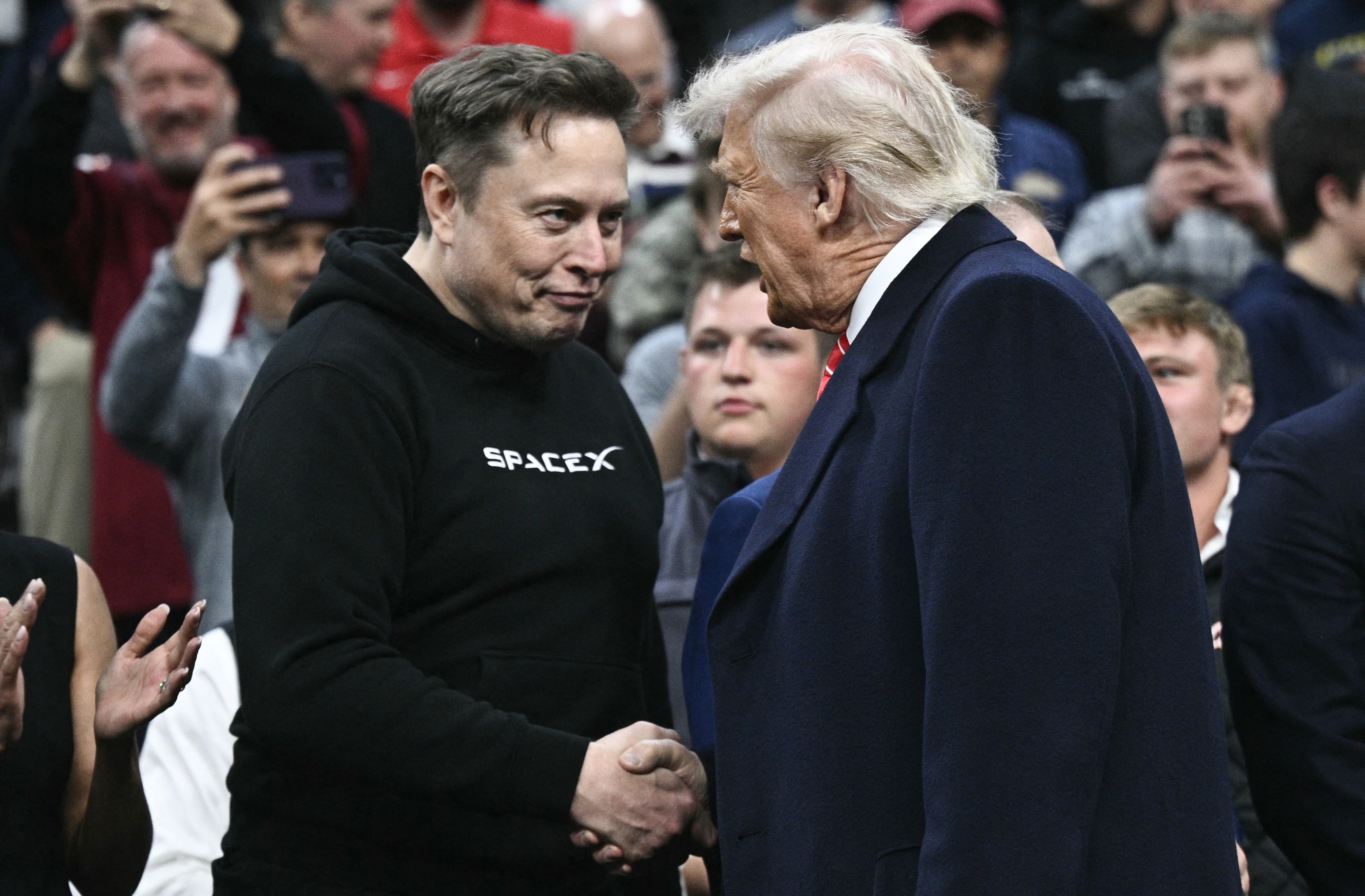 Elon Musk and Donald Trump shaking hands