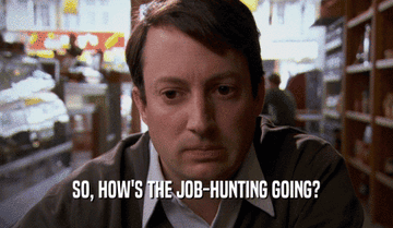 A man sits in a diner with a concerned expression. Text on screen reads, "So, how's the job-hunting going?"