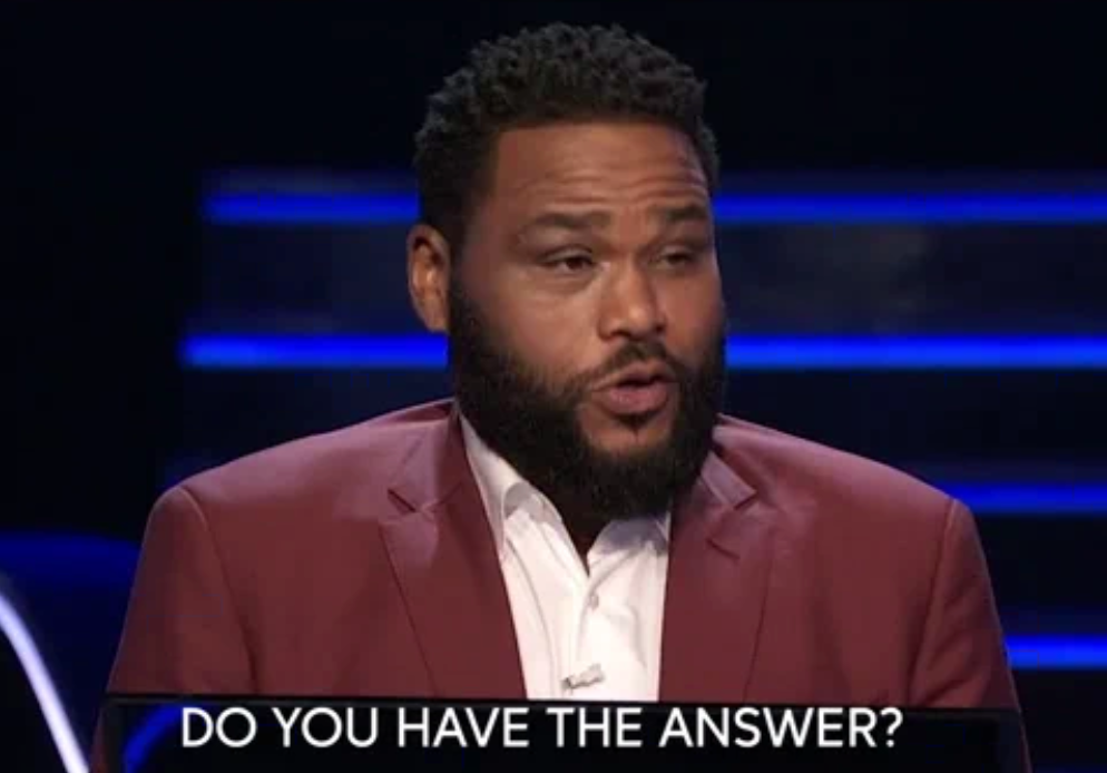 A person in a suit on a game show set, looking expectant, with text overlay asking, "Do you have the answer?"
