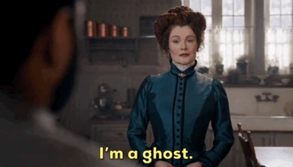 Victorian-dressed woman stands confidently, saying "I'm a ghost" in a vintage-style room