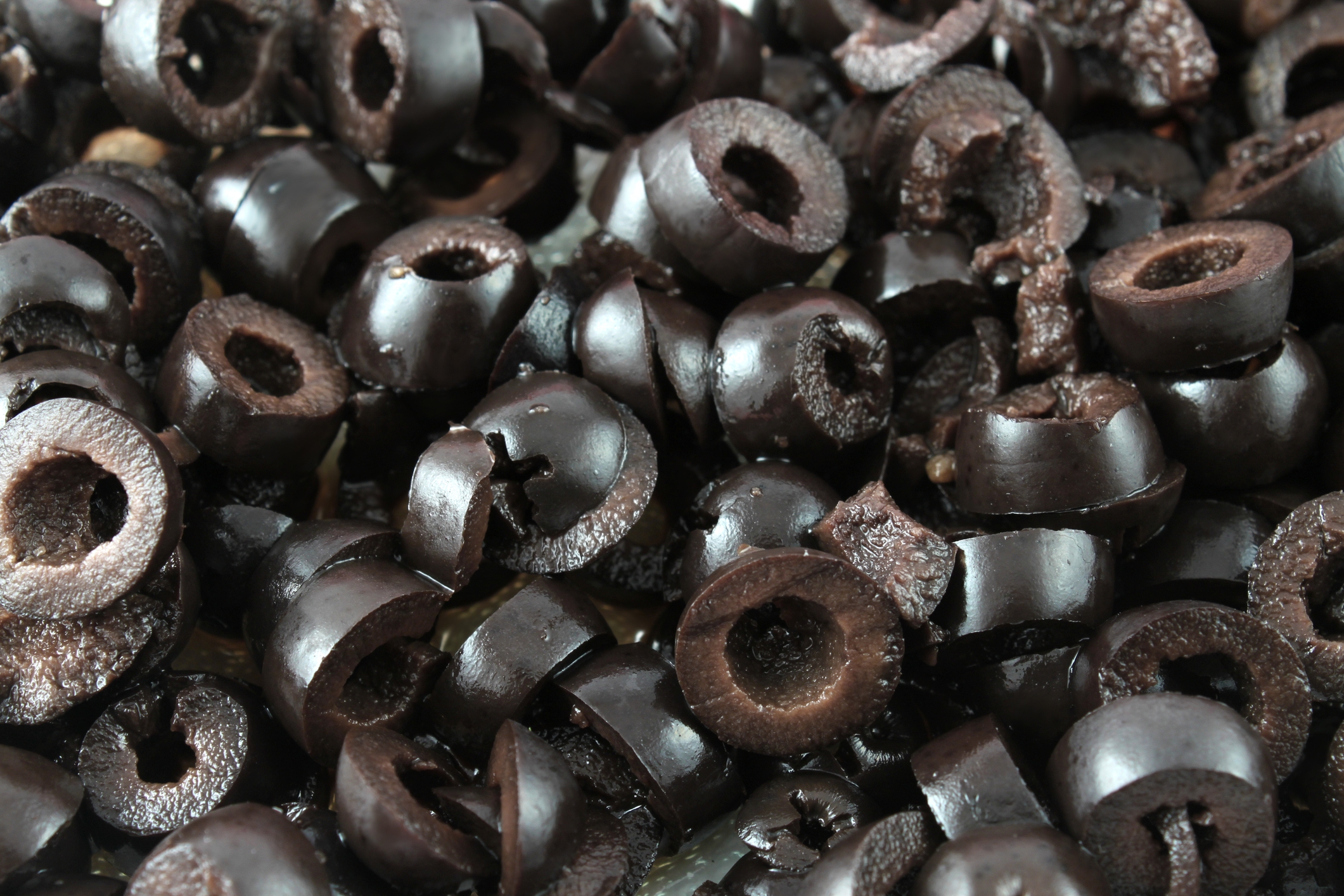 Close-up of sliced black olives piled together